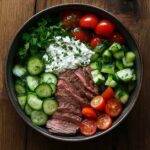 Beef cottage cheese bowl with fresh vegetables and herbs