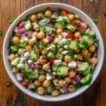 Chickpea salad with cucumber and feta in a white bowl