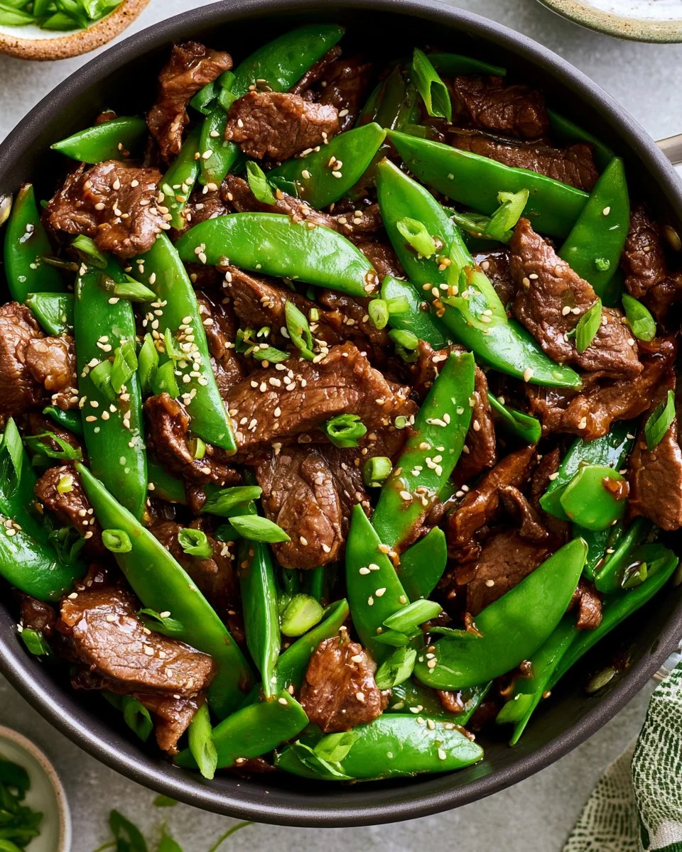 Beef stir fry with colorful vegetables in a skillet