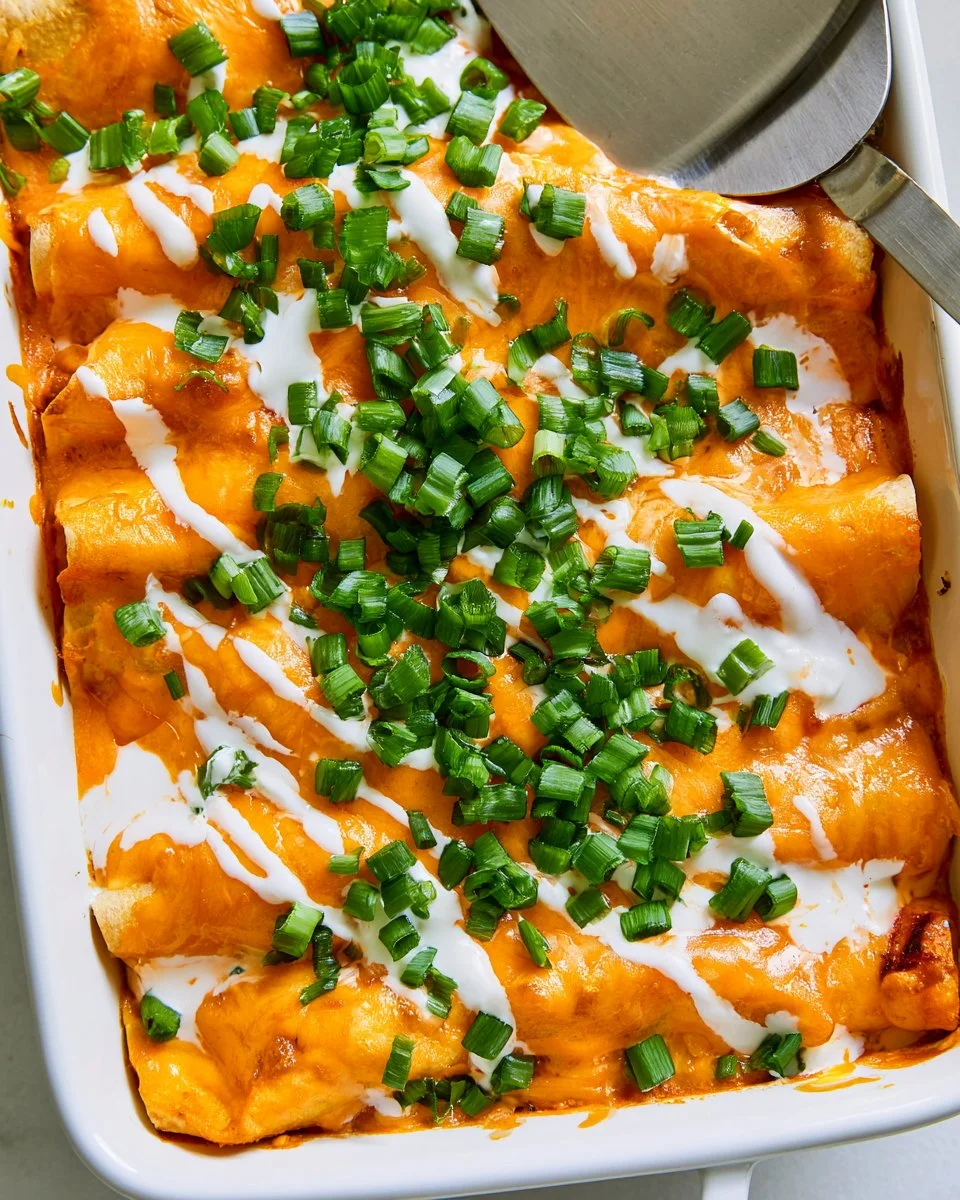 Delicious Buffalo Chicken Enchiladas garnished with green onions