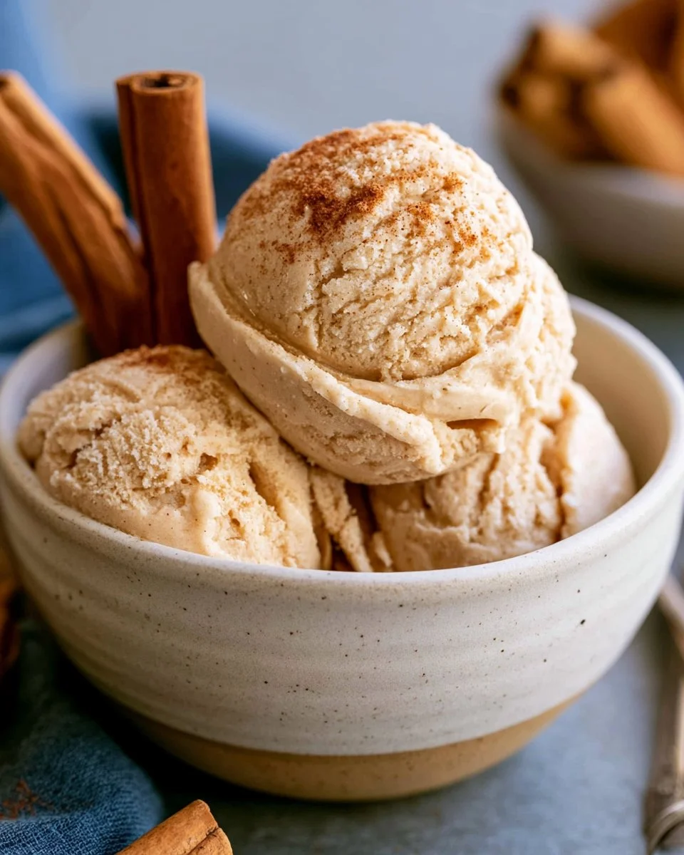 Delicious bowl of creamy cinnamon ice cream with a sprinkle of cinnamon on top