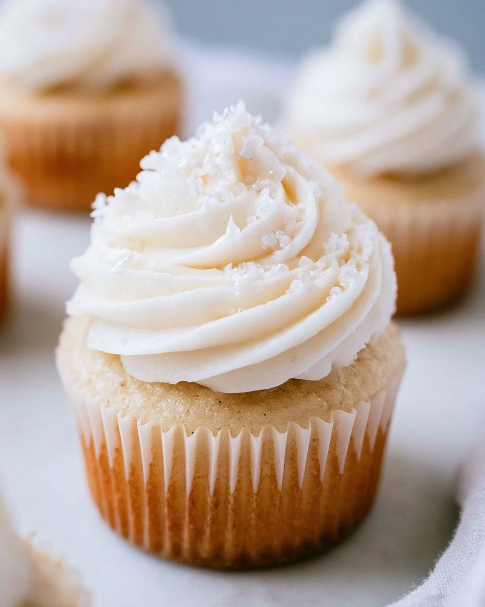 Healthy vanilla cupcakes with frosting on a dessert table