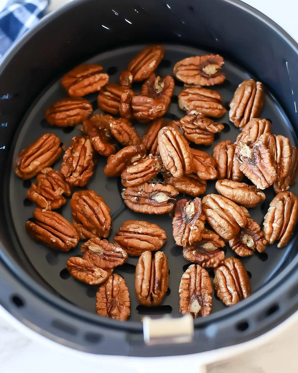 Bowl of perfectly roasted pecans made in an air fryer.