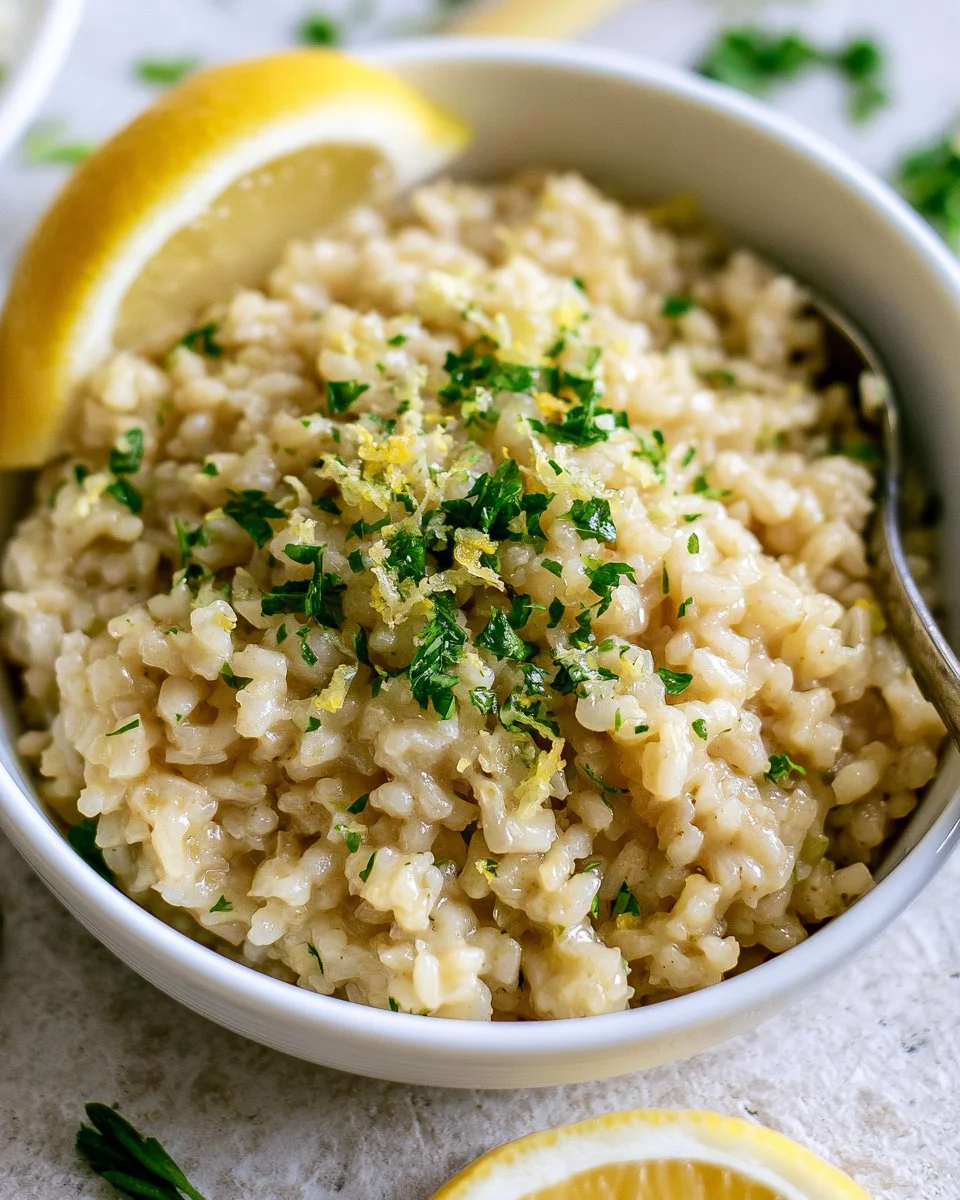 Bowl of flavorful lemon rice garnished with fresh herbs and lemon slices