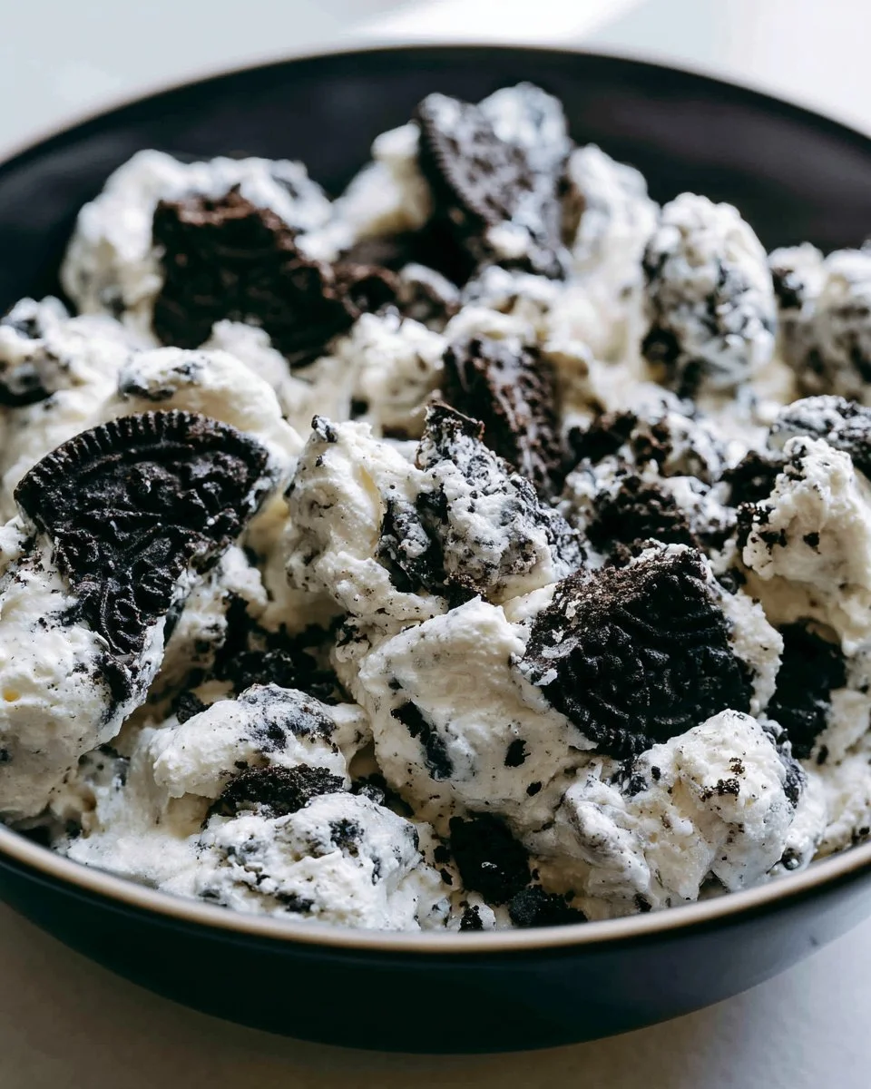 Oreo Fluff Dessert Salad with crushed Oreos and whipped cream in a bowl