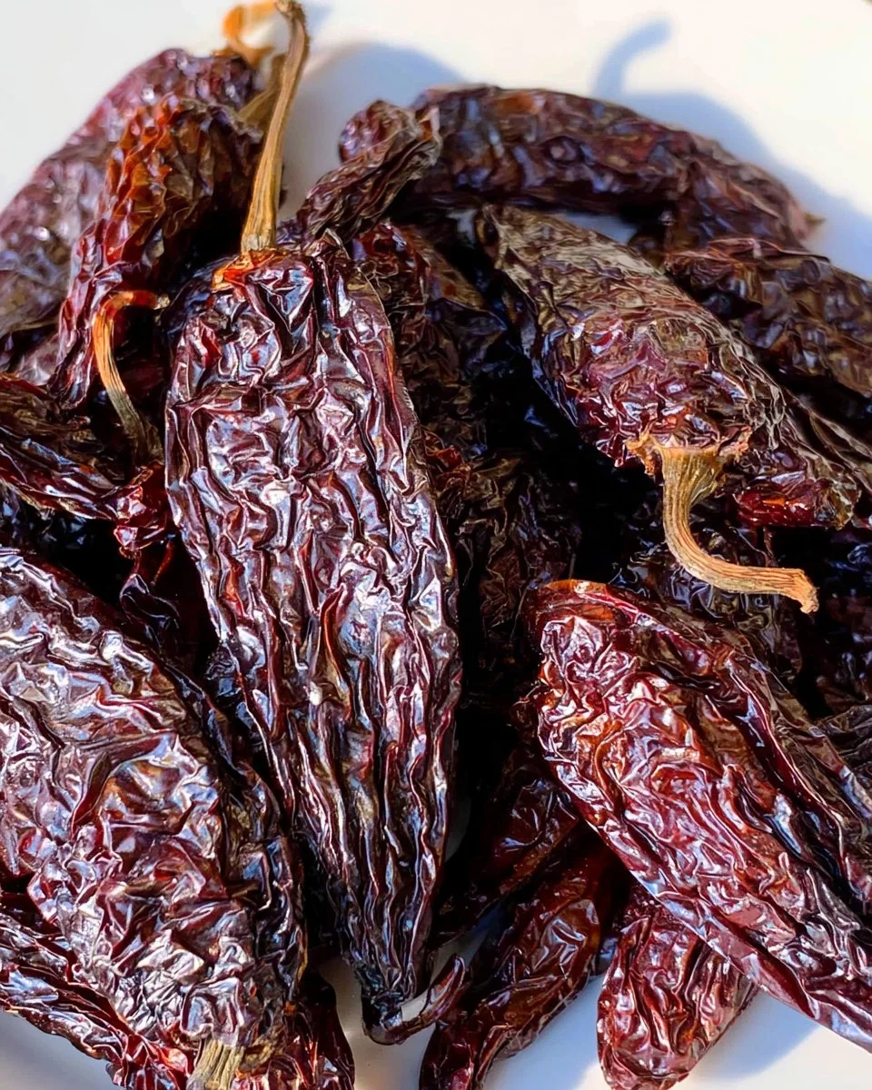 Bowl of smoked chipotles, showcasing their rich color and smoky flavor.