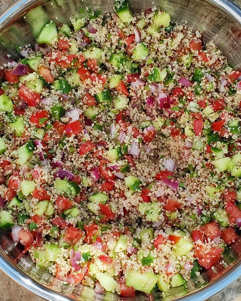 Bowl of vibrant Quinoa Tabouli salad with fresh vegetables and herbs
